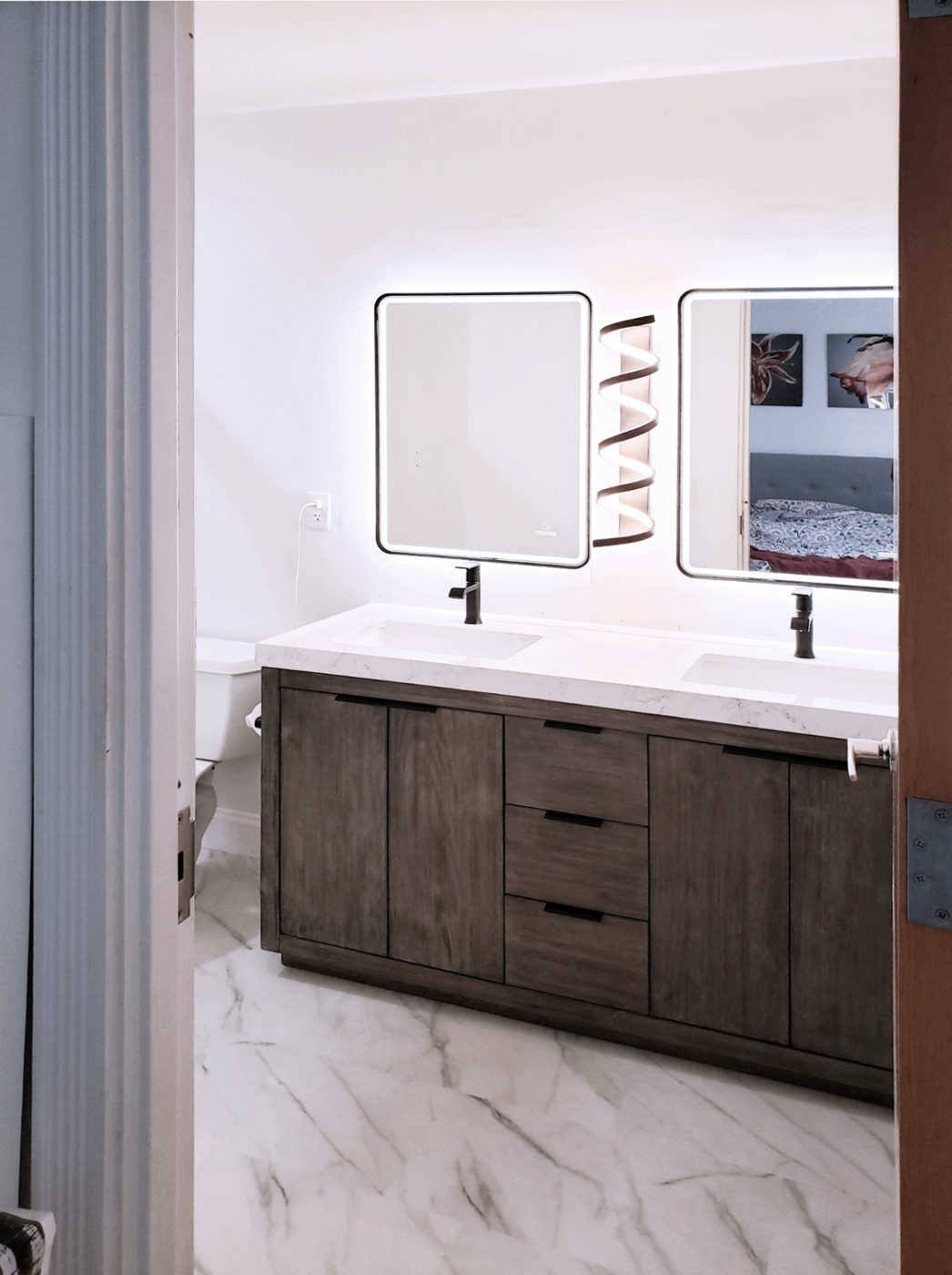 Double vanity with backlit mirrors