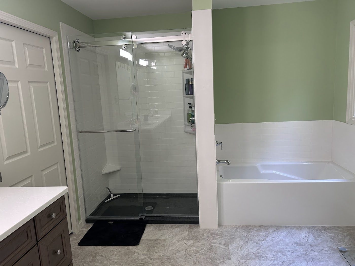 Walk-in shower beside a soaking tub