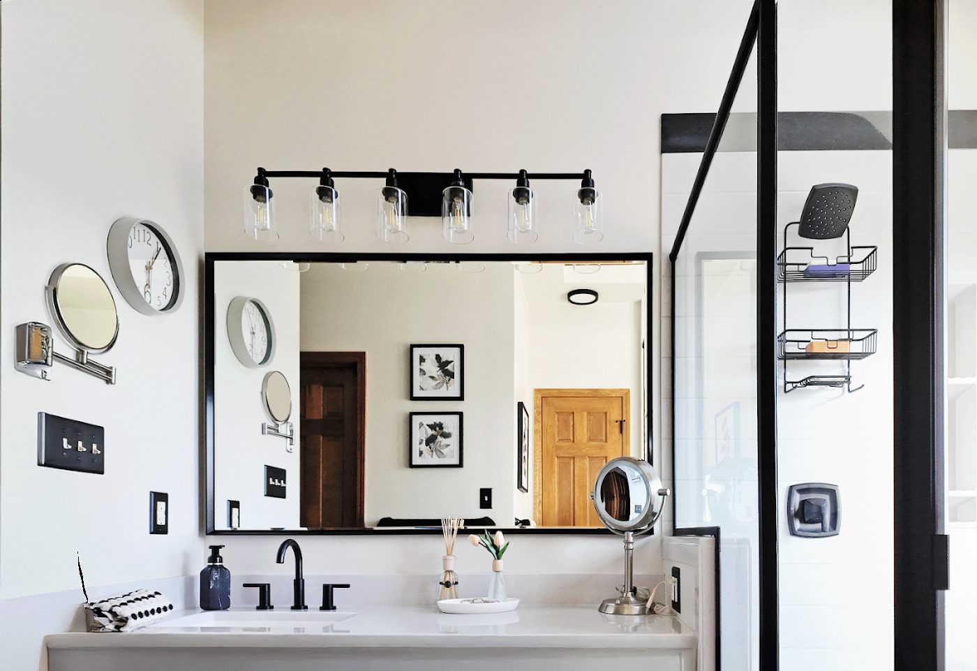 Vanity remodel with black-framed glass