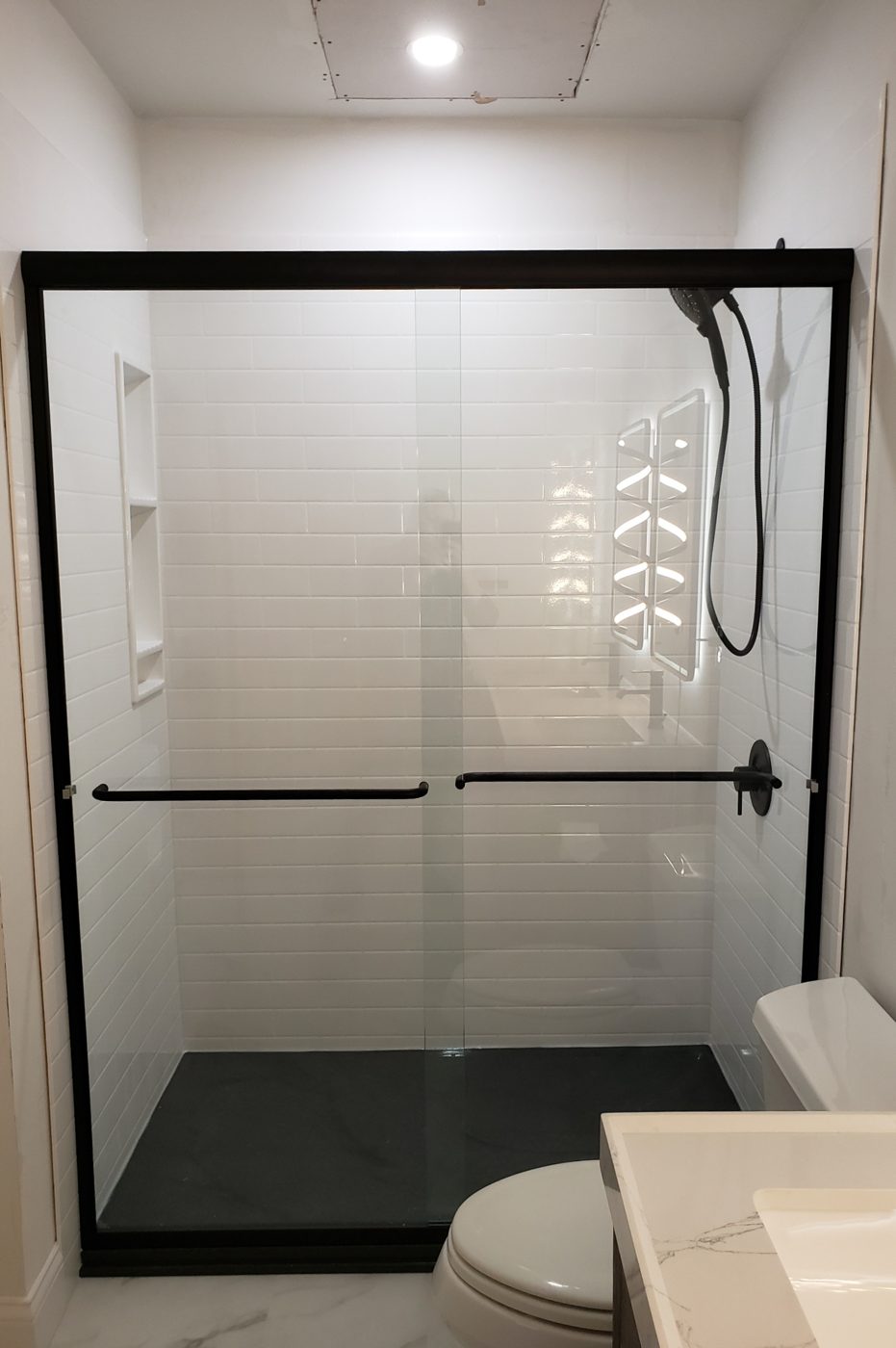 Frameless sliding glass on a tiled shower